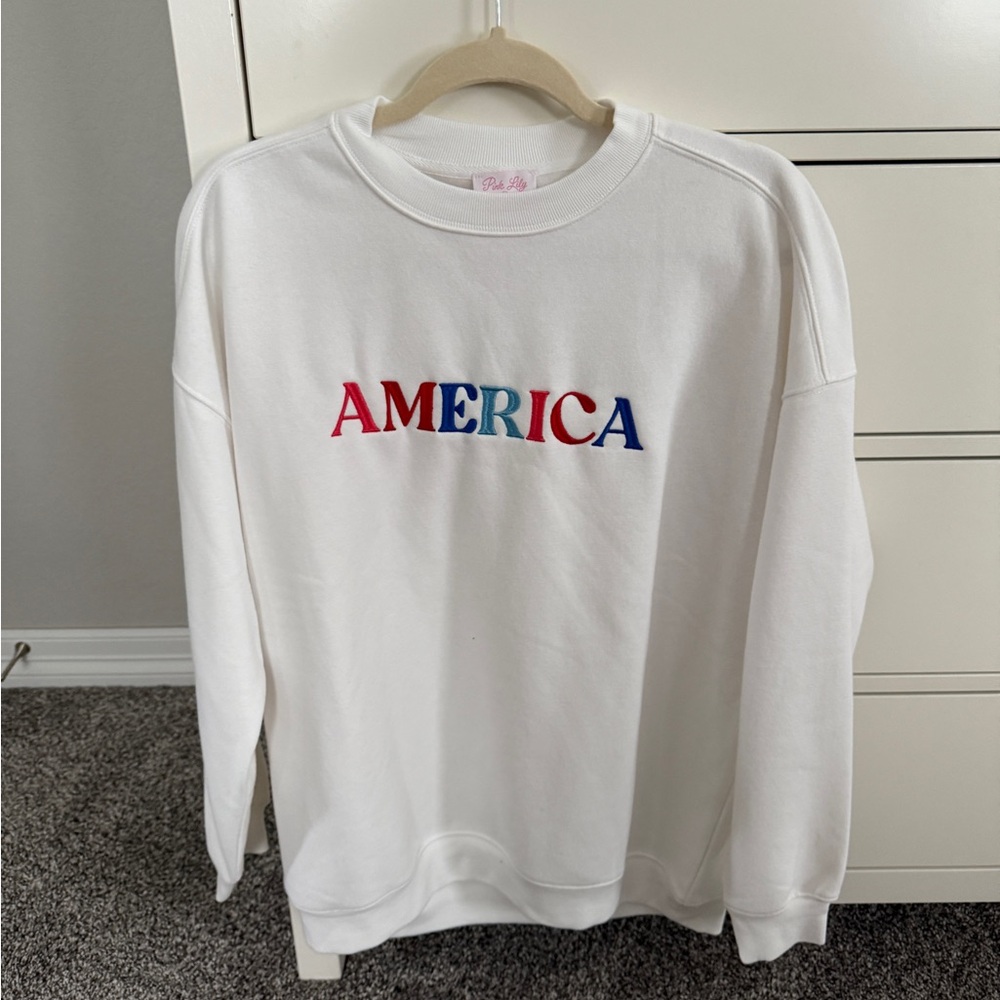Pink Lily White Crew Neck Sweater with Red and Blue Accents